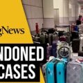 Abandoned suitcases line Manchester Airport baggage hall as passengers told to go home